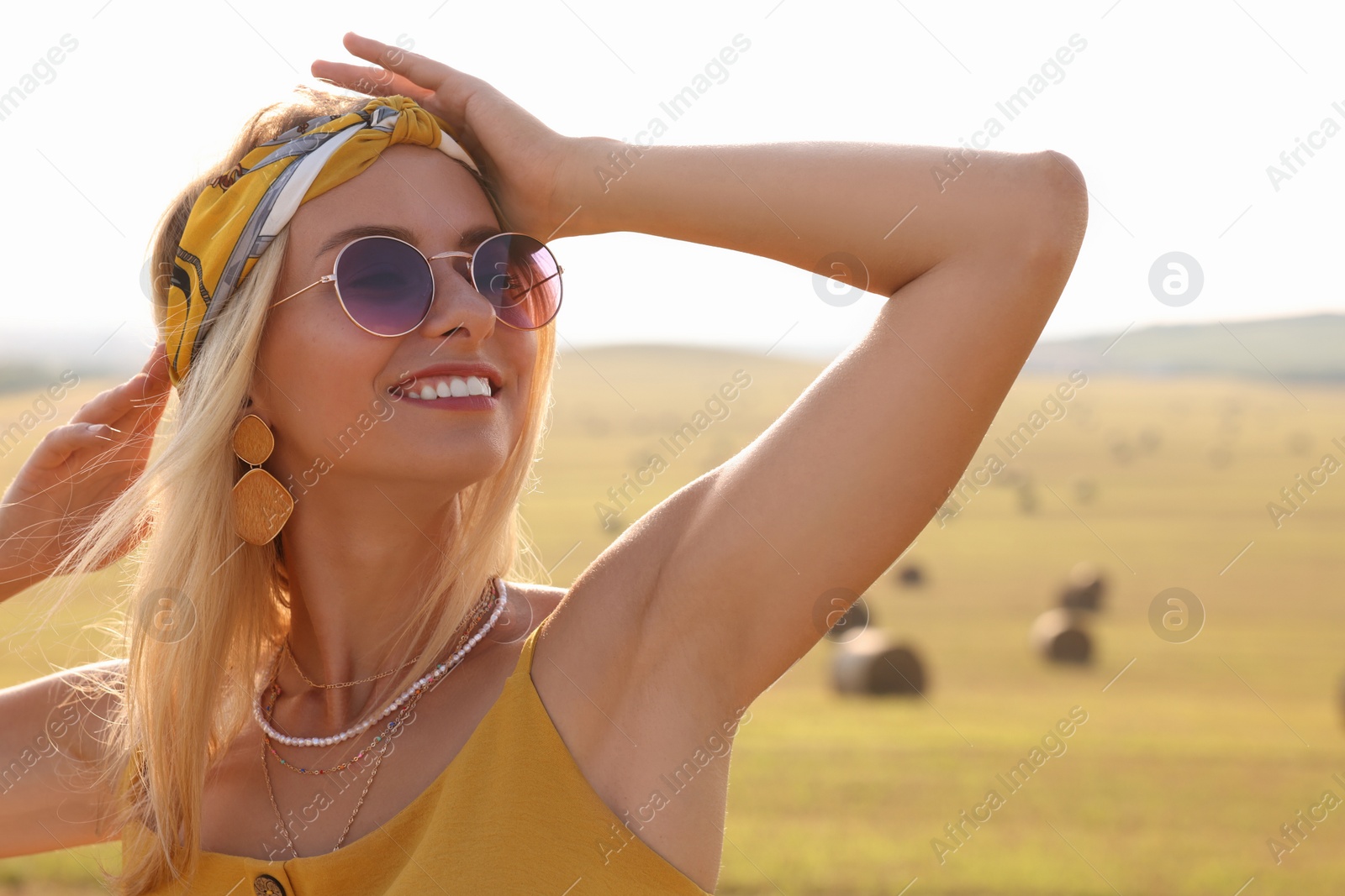 Photo of Portrait of beautiful happy hippie woman in field