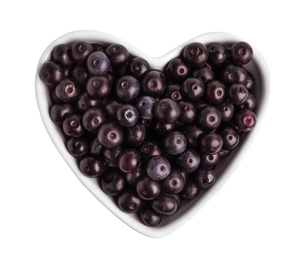 Photo of Heart shaped bowl with fresh acai berries on white background, top view