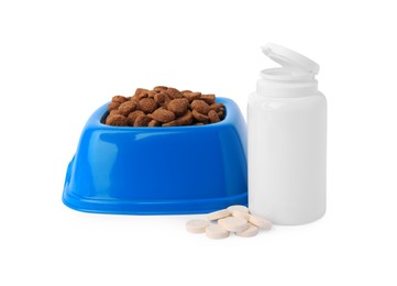 Photo of Dry pet food in bowl, vitamins and bottle isolated on white