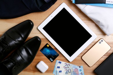 Photo of Business trip stuff on wooden surface, flat lay