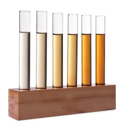 Photo of Test tubes with brown liquid in stand on white background