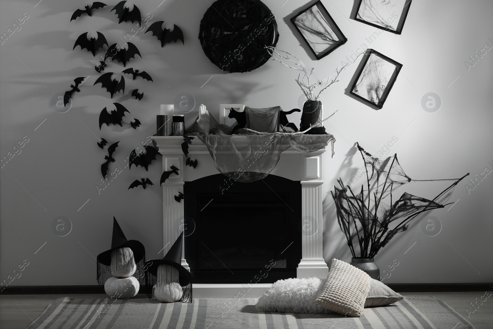 Photo of Stylish room with fireplace decorated for Halloween