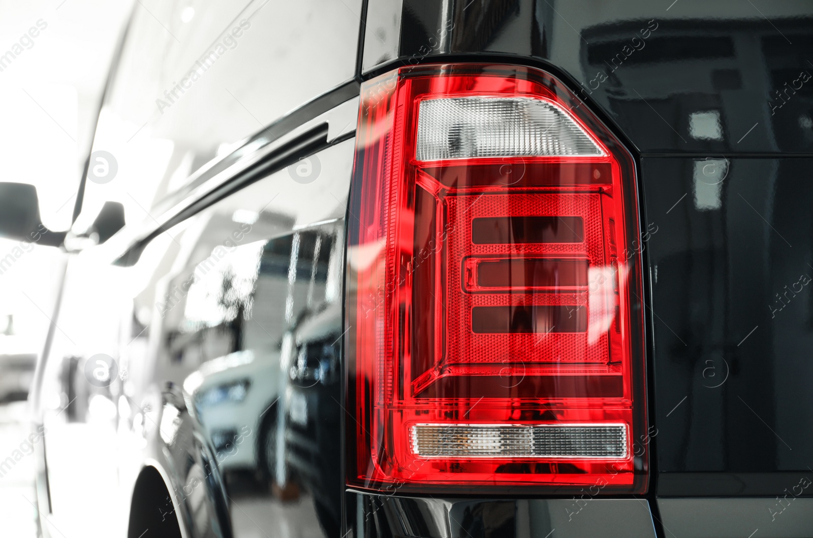 Photo of New luxury car in modern auto dealership, closeup