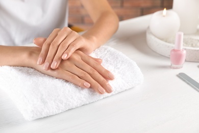 Photo of Woman showing neat manicure at table, closeup with space for text. Spa treatment