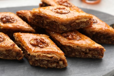 Delicious sweet baklava with walnuts on board, closeup