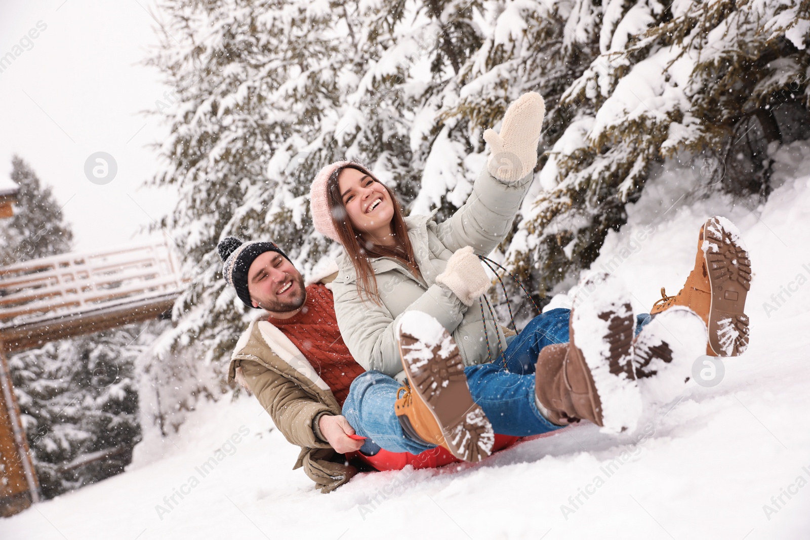 Photo of Couple having fun outdoors on snowy day. Winter vacation