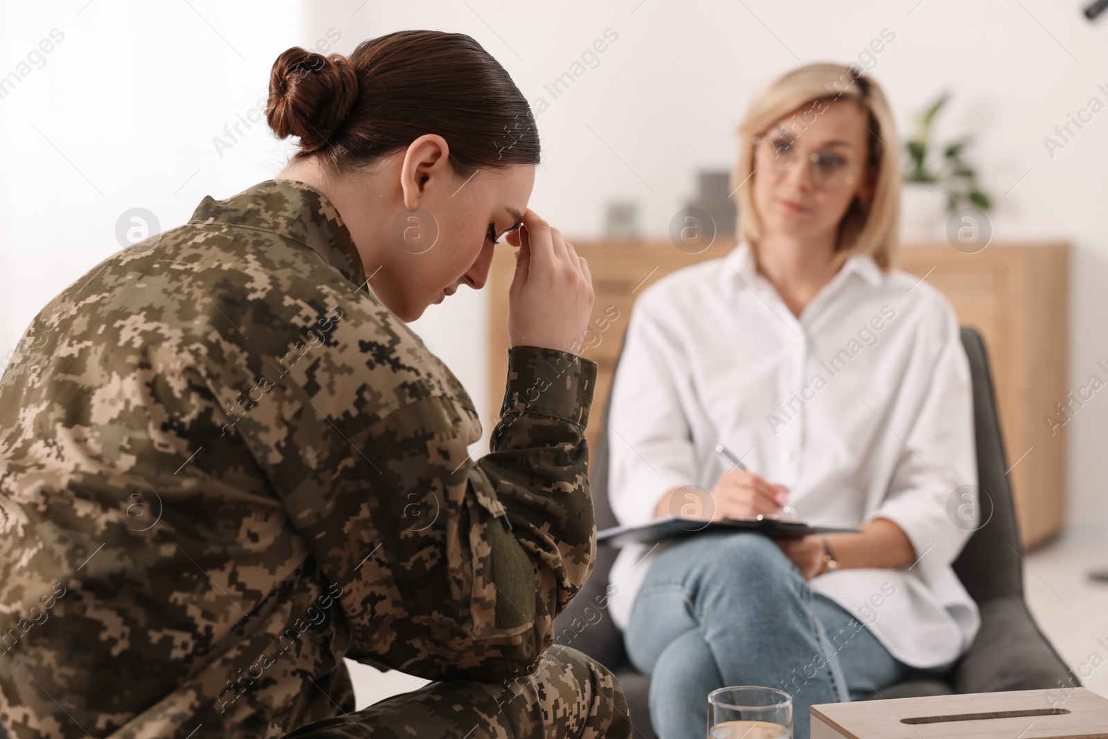 Photo of Psychotherapist working with military woman in office