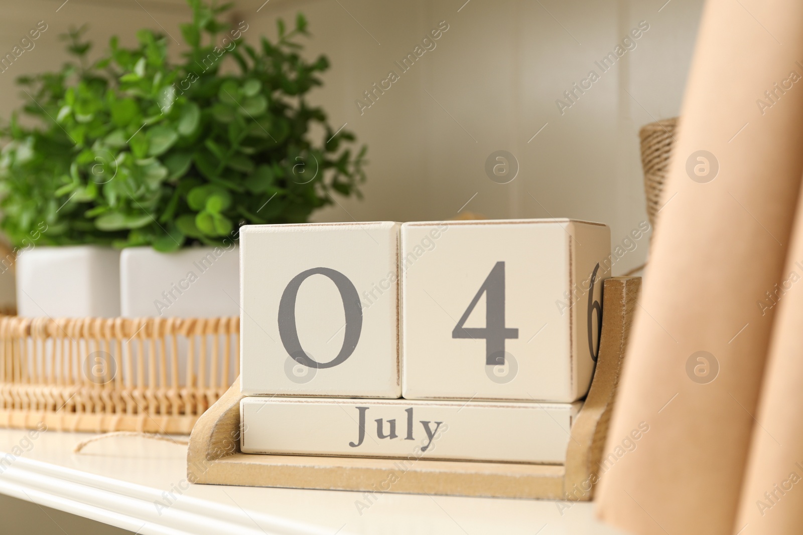 Photo of White shelving unit with calendar and decorative elements
