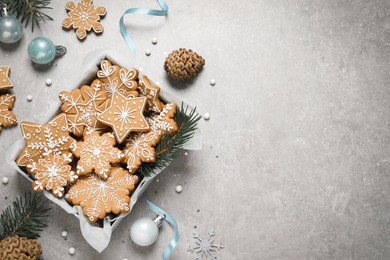 Photo of Tasty Christmas cookies and festive decor on light grey table, flat lay. Space for text