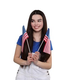 4th of July - Independence day of America. Happy teenage girl holding national flags of United States on white background