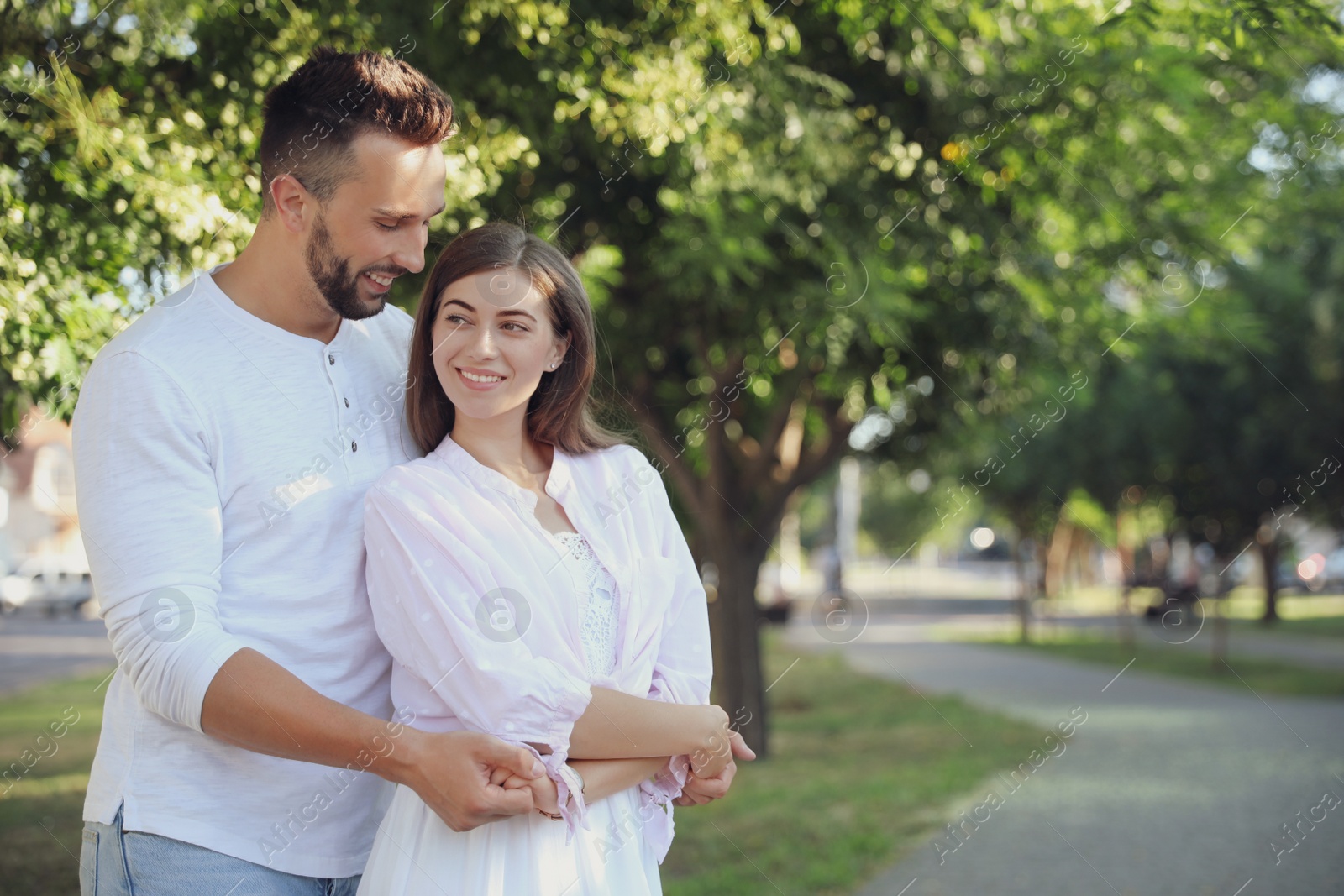 Photo of Lovely young couple dancing together in park on sunny day