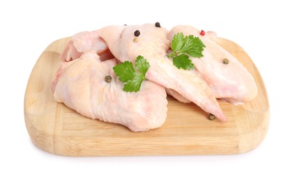 Raw chicken wings with spices and parsley on white background