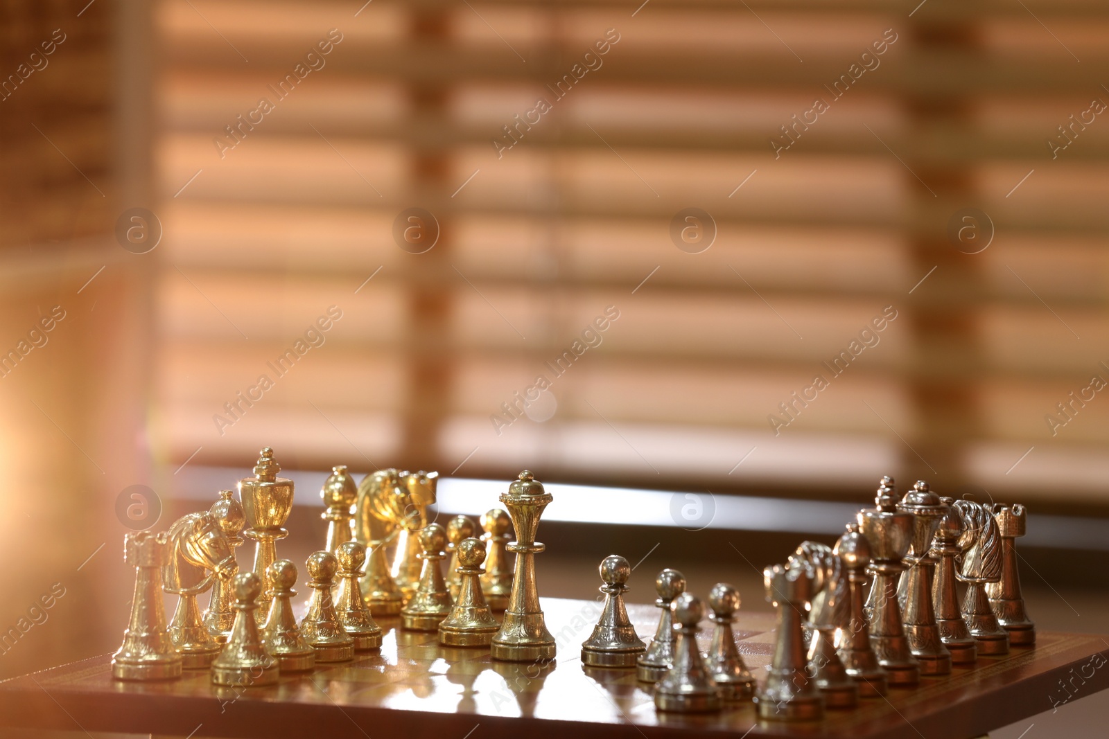 Photo of Chessboard with game pieces near window indoors, space for text