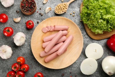 Photo of Fresh raw vegetarian sausages, soybeans and vegetables on grey table, flat lay