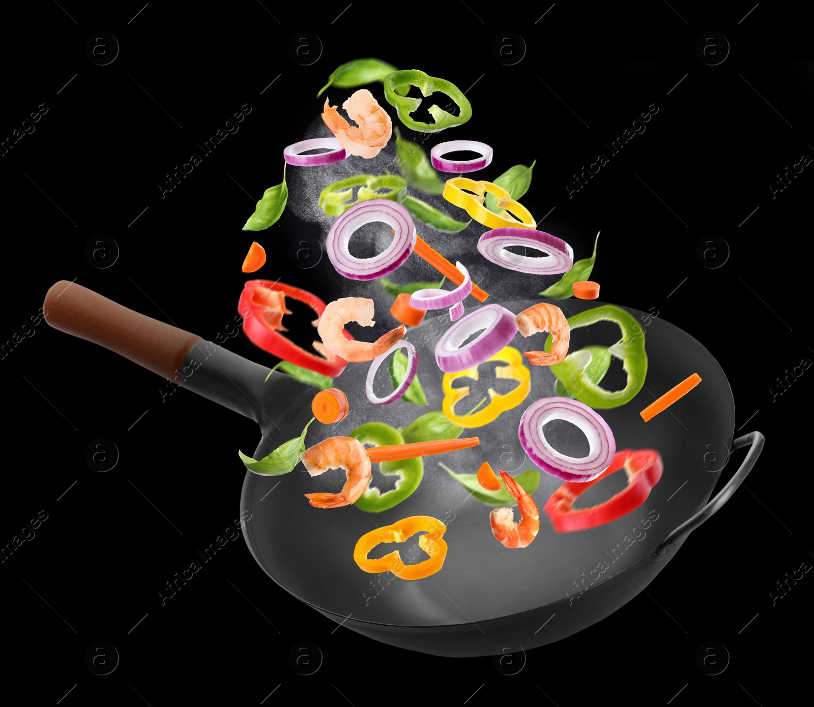 Image of Different tasty ingredients falling into wok on black background