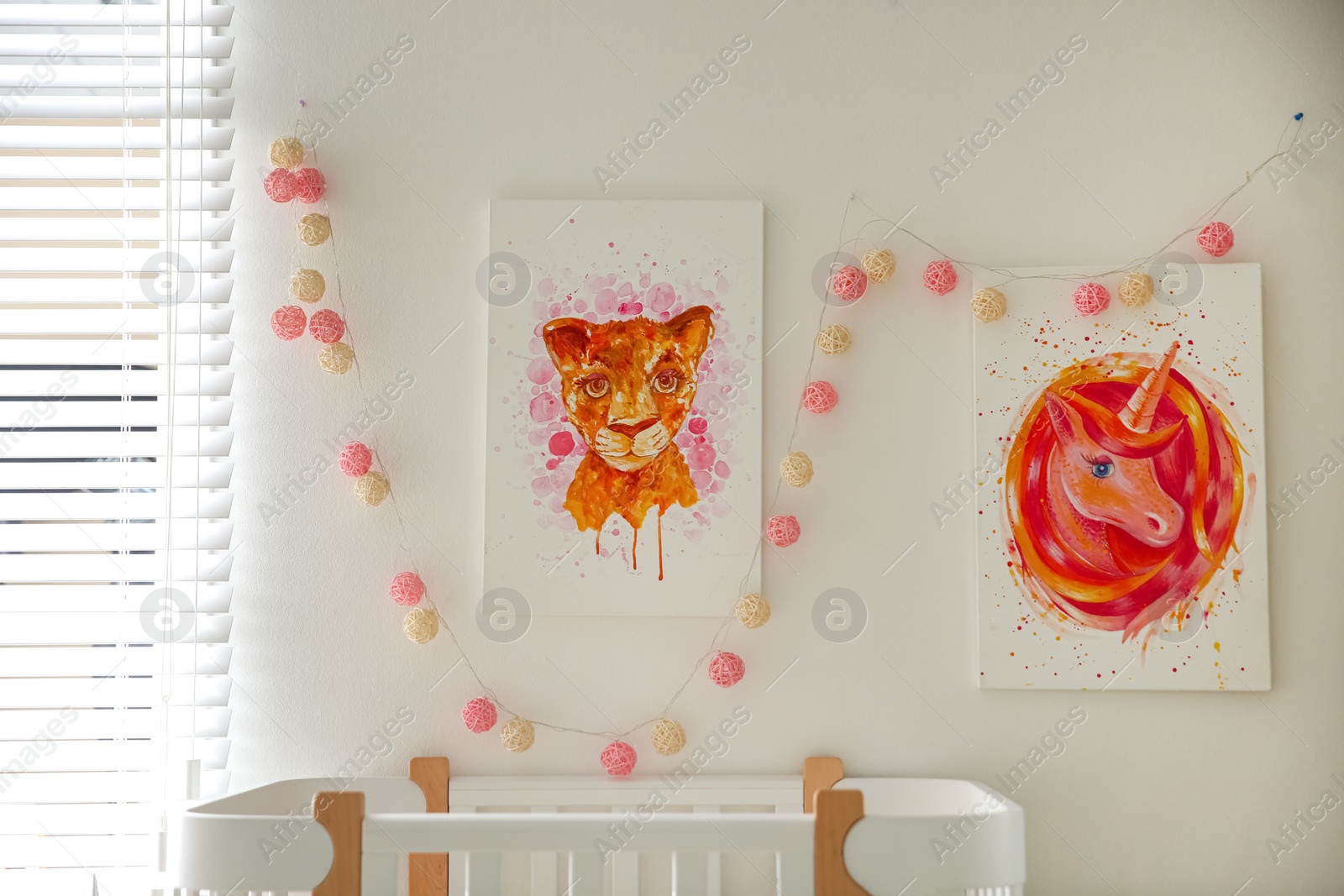 Photo of Cute pictures on white wall in baby room interior