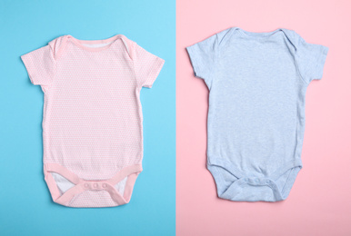 Photo of Child's bodysuit on light blue and pink background, flat lay