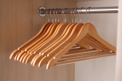 Photo of Set of clothes hangers on wardrobe rail
