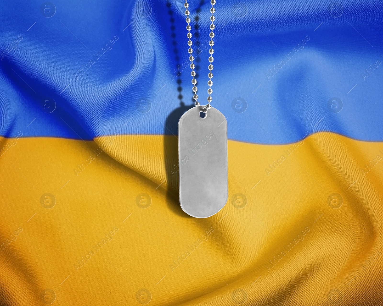 Image of Military ID tag and Ukrainian flag on background