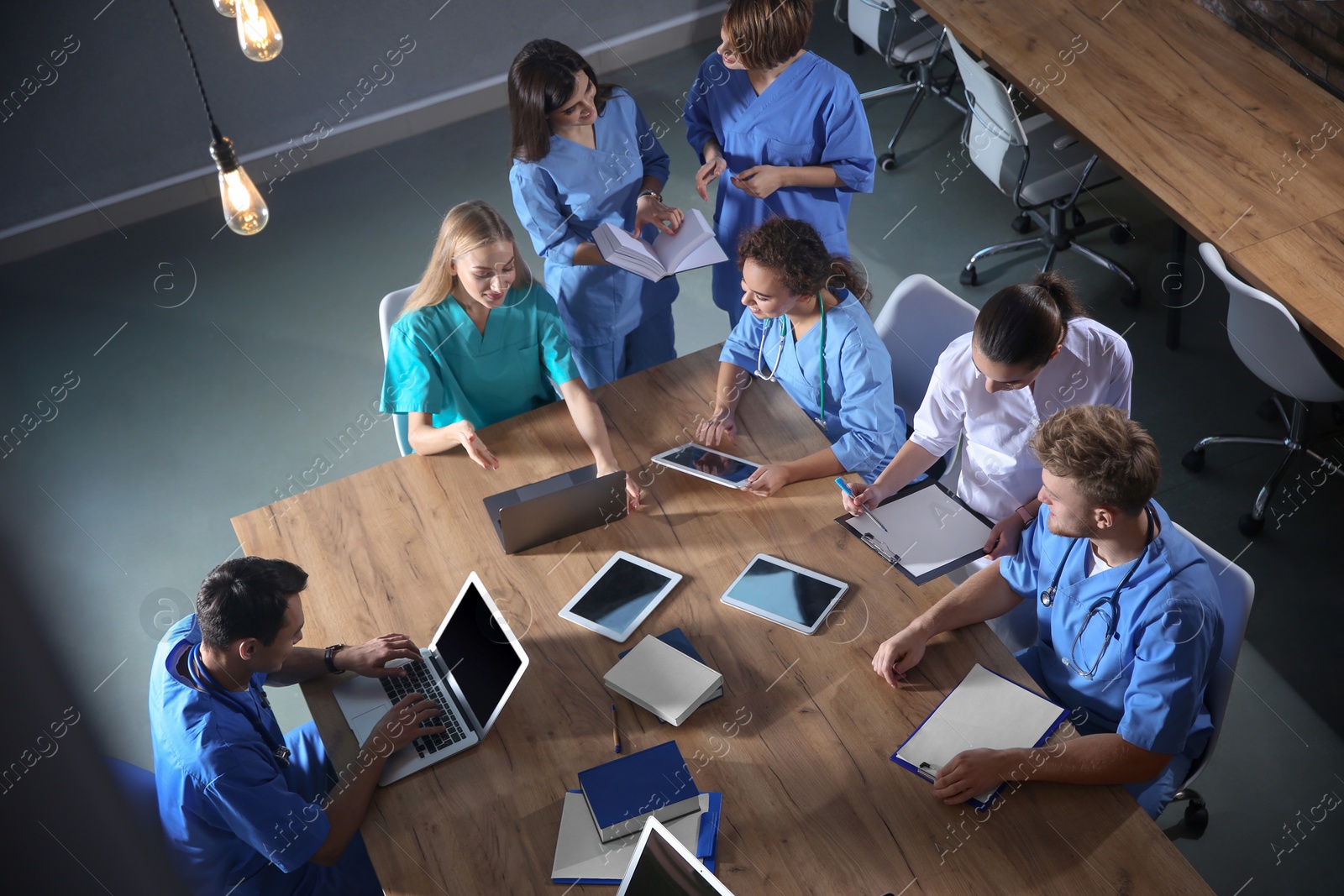 Photo of Group of medical students with gadgets in college, top view