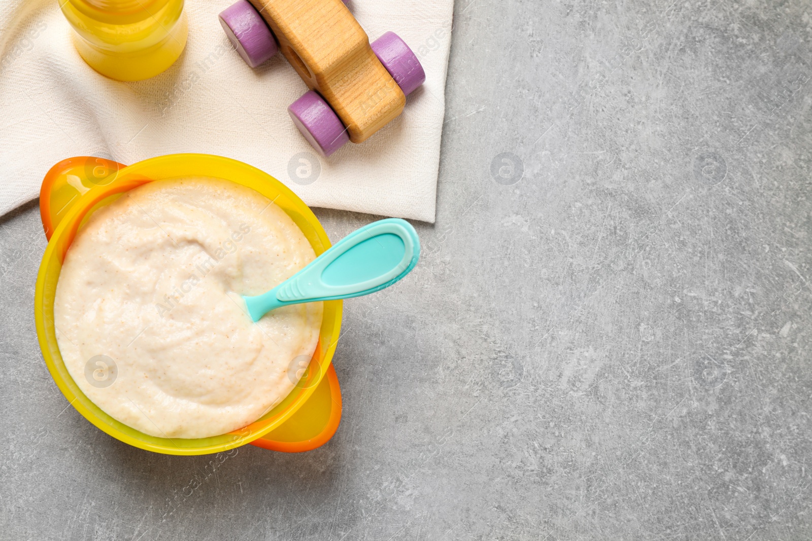 Photo of Flat lay composition with healthy baby food on grey table, space for text