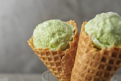 Delicious pistachio ice cream on grey background, closeup