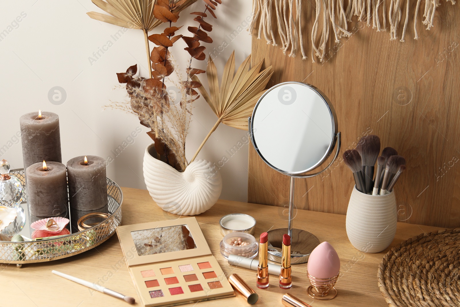 Photo of Dressing table with mirror and makeup products in room
