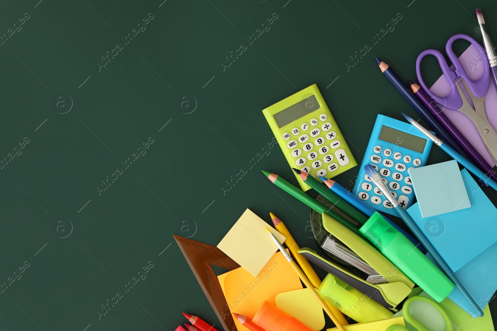 Photo of Flat lay composition with different school stationery on green chalkboard, space for text. Back to school