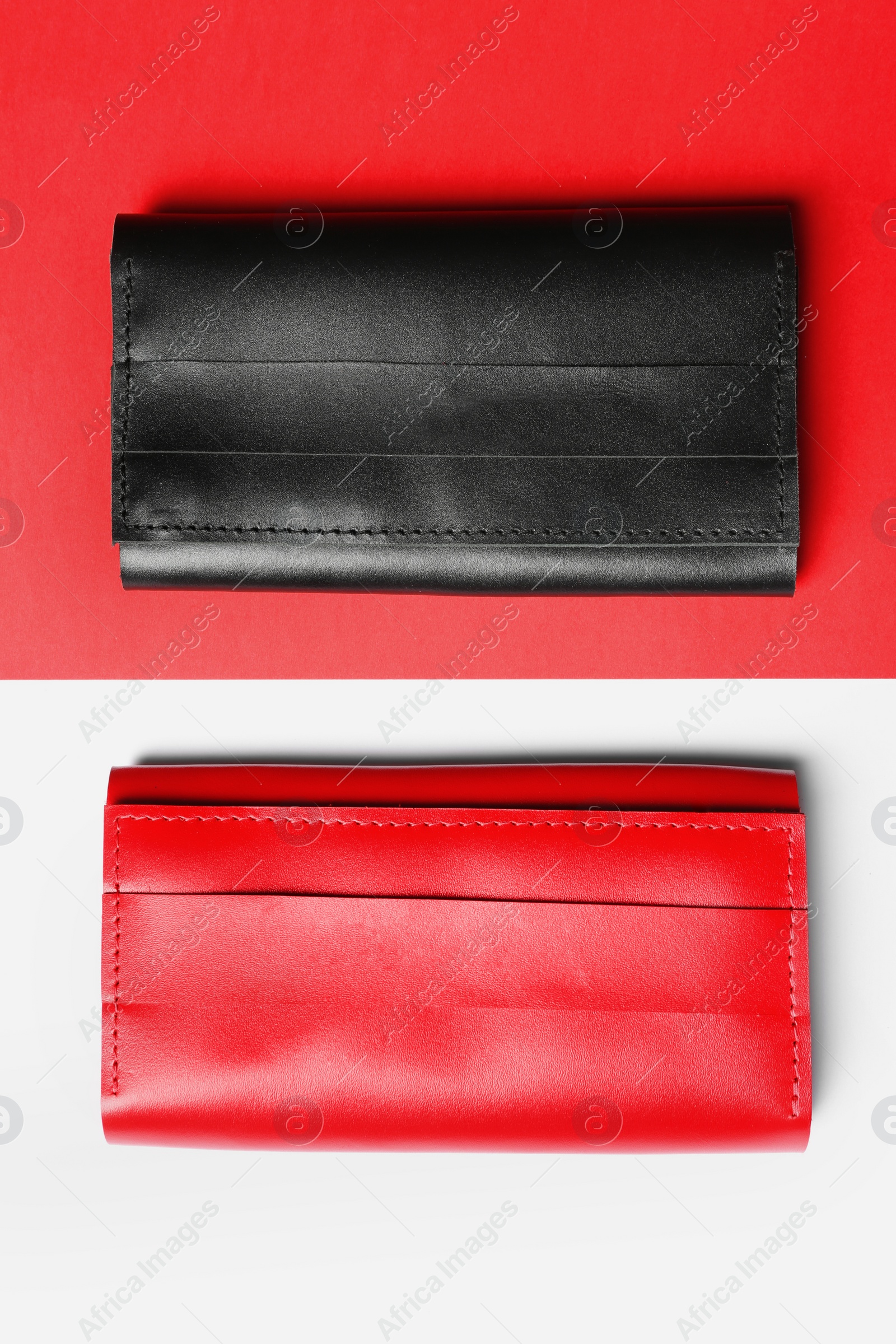 Photo of Stylish wallets on color background, top view