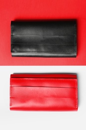 Photo of Stylish wallets on color background, top view