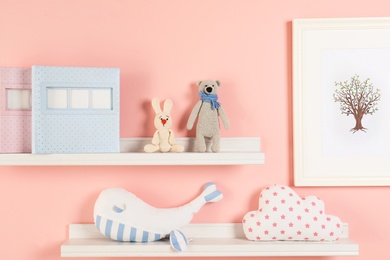 Toys and albums on shelves in child room