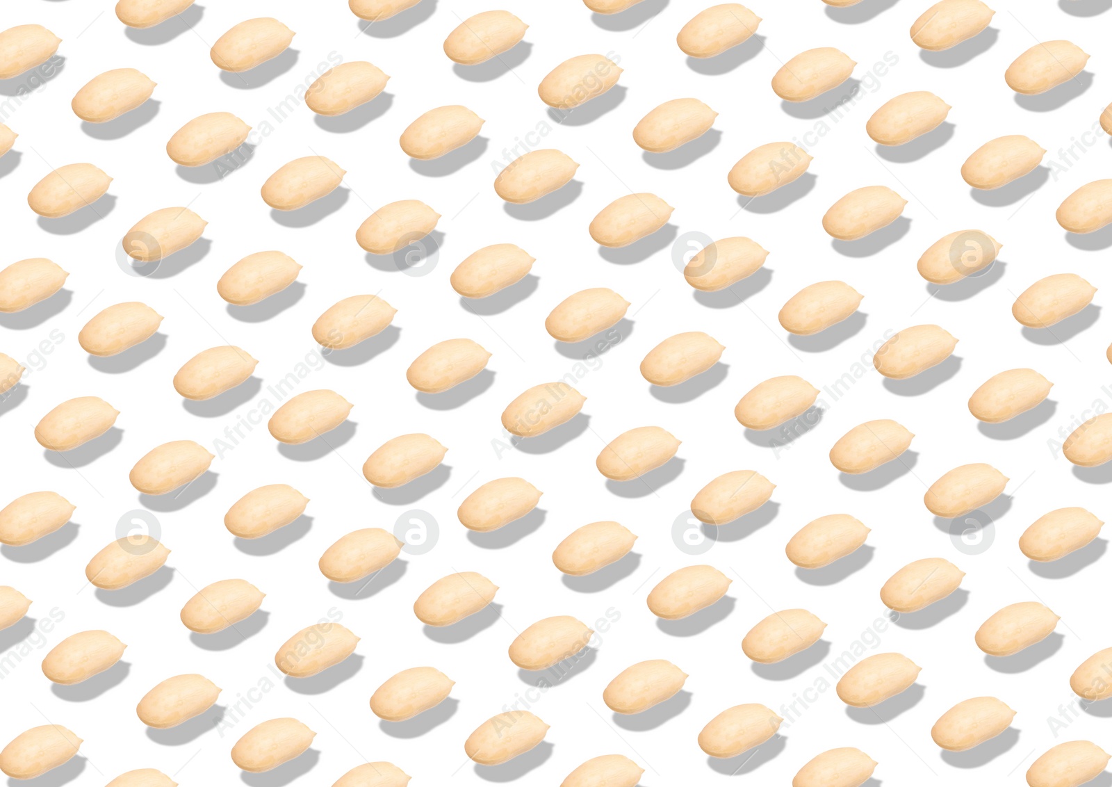 Image of Pattern of peeled peanuts on white background