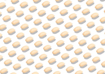 Pattern of peeled peanuts on white background