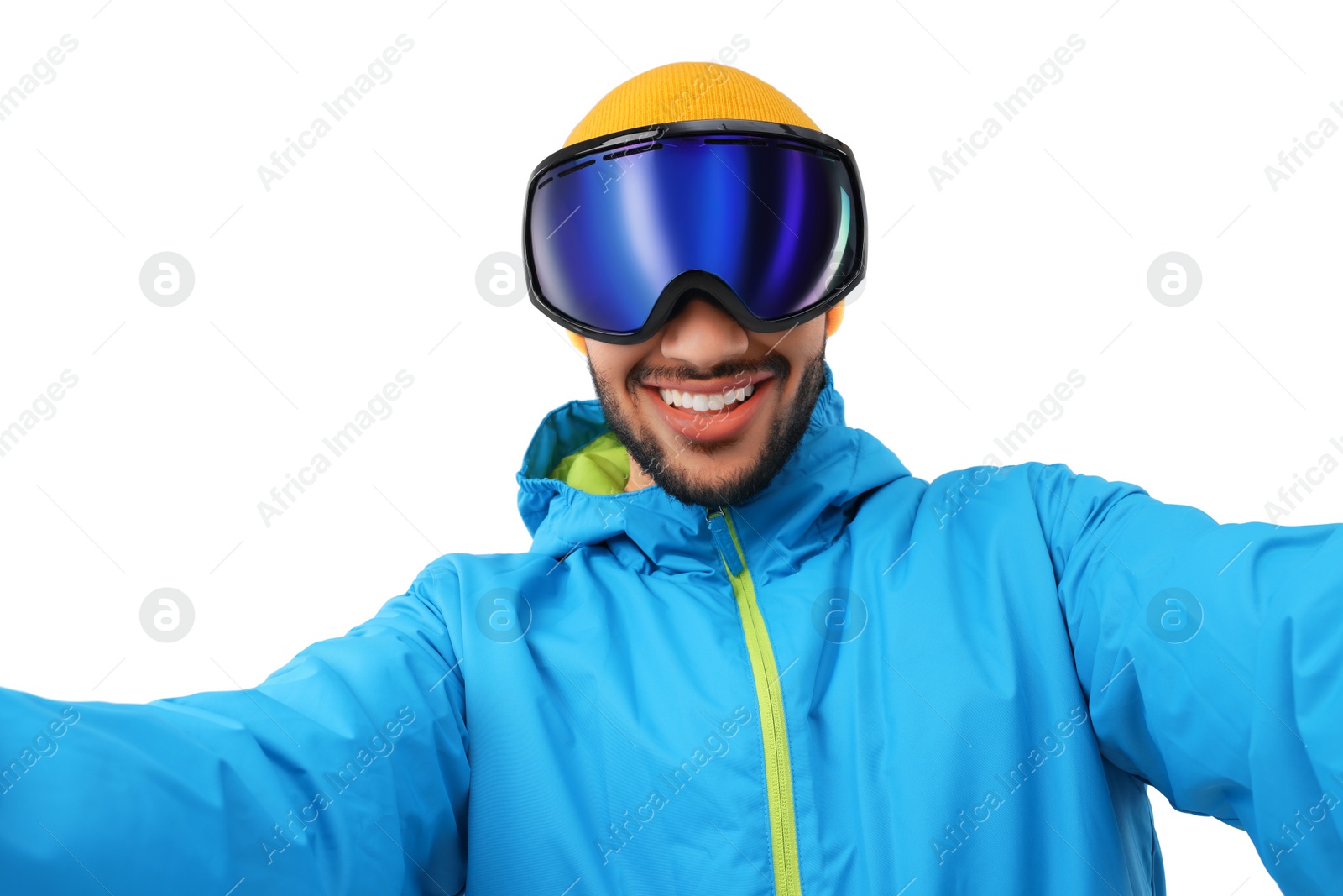 Photo of Smiling young man in ski goggles taking selfie on white background