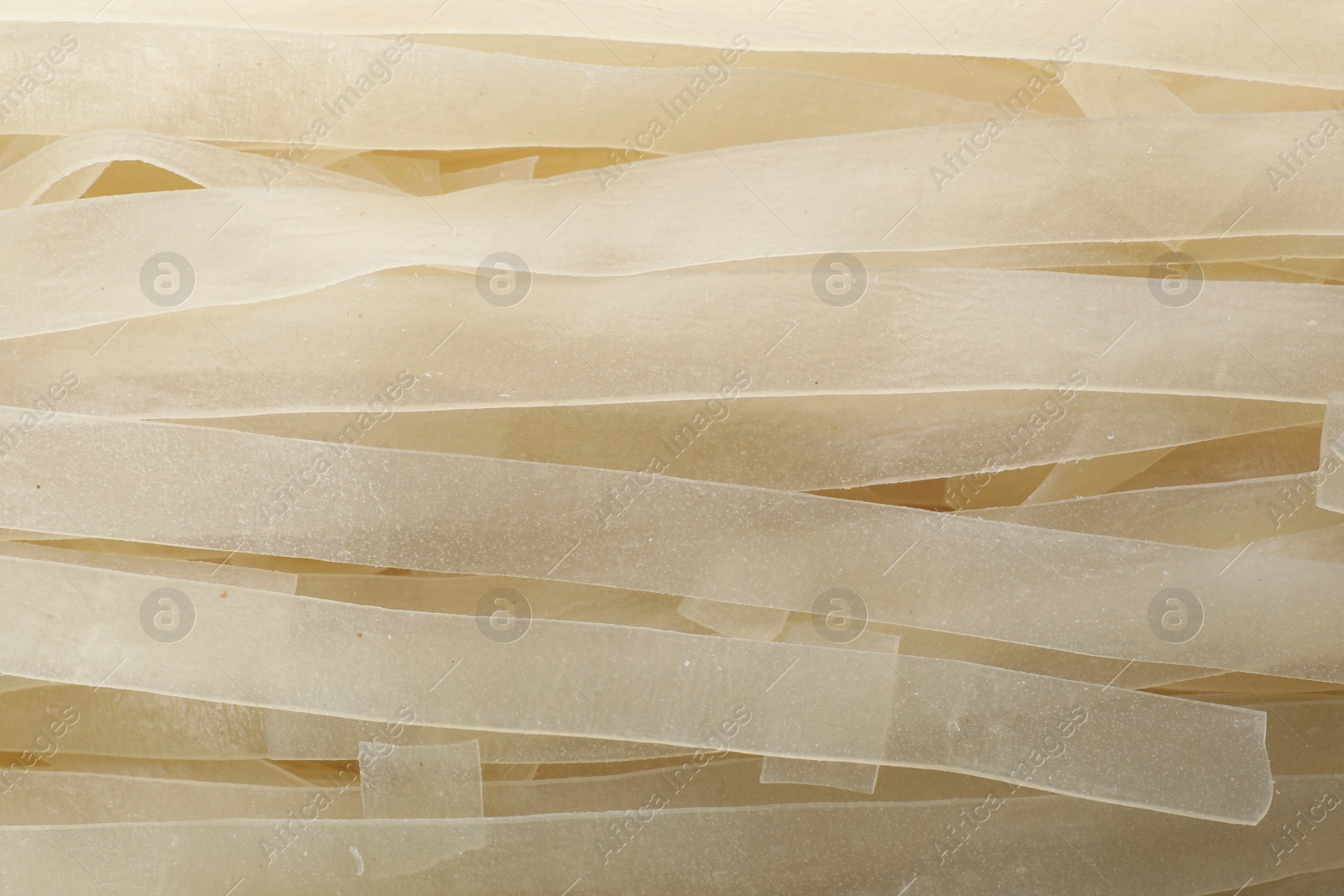 Photo of Raw rice noodles as background, closeup view