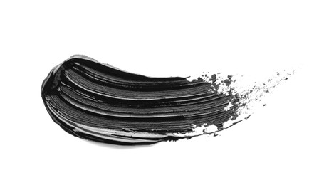 Photo of Brushstroke of black oil paint on white background, top view