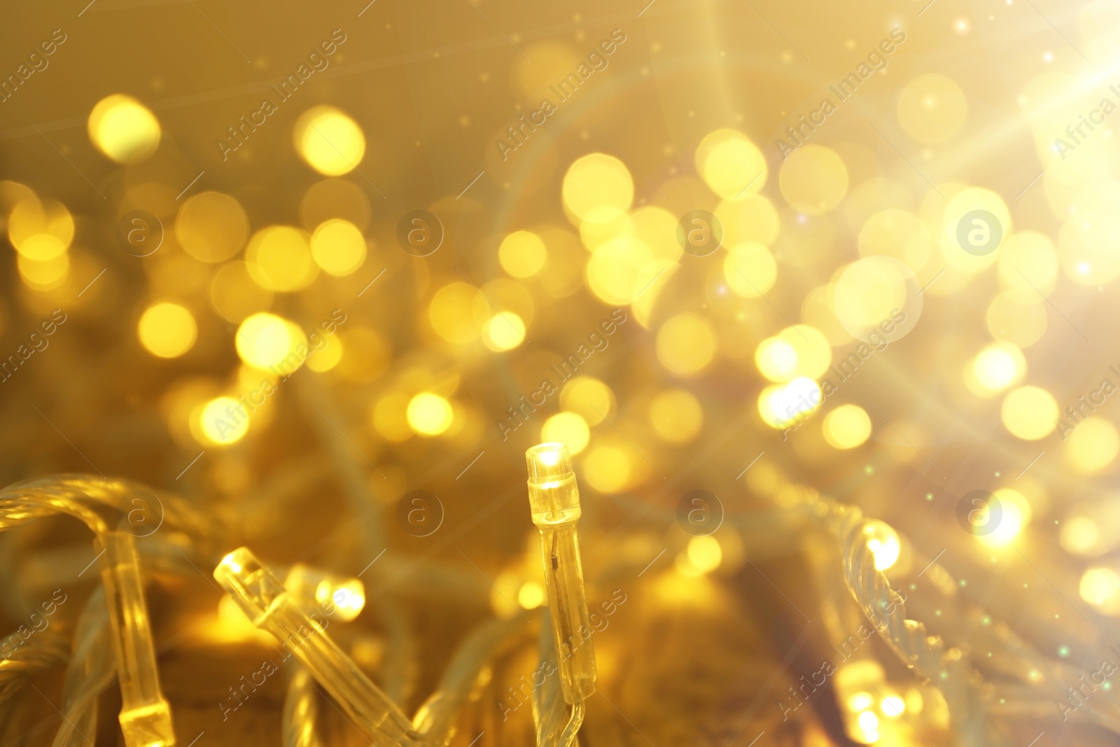 Image of Glowing Christmas lights, closeup view. Bokeh effect