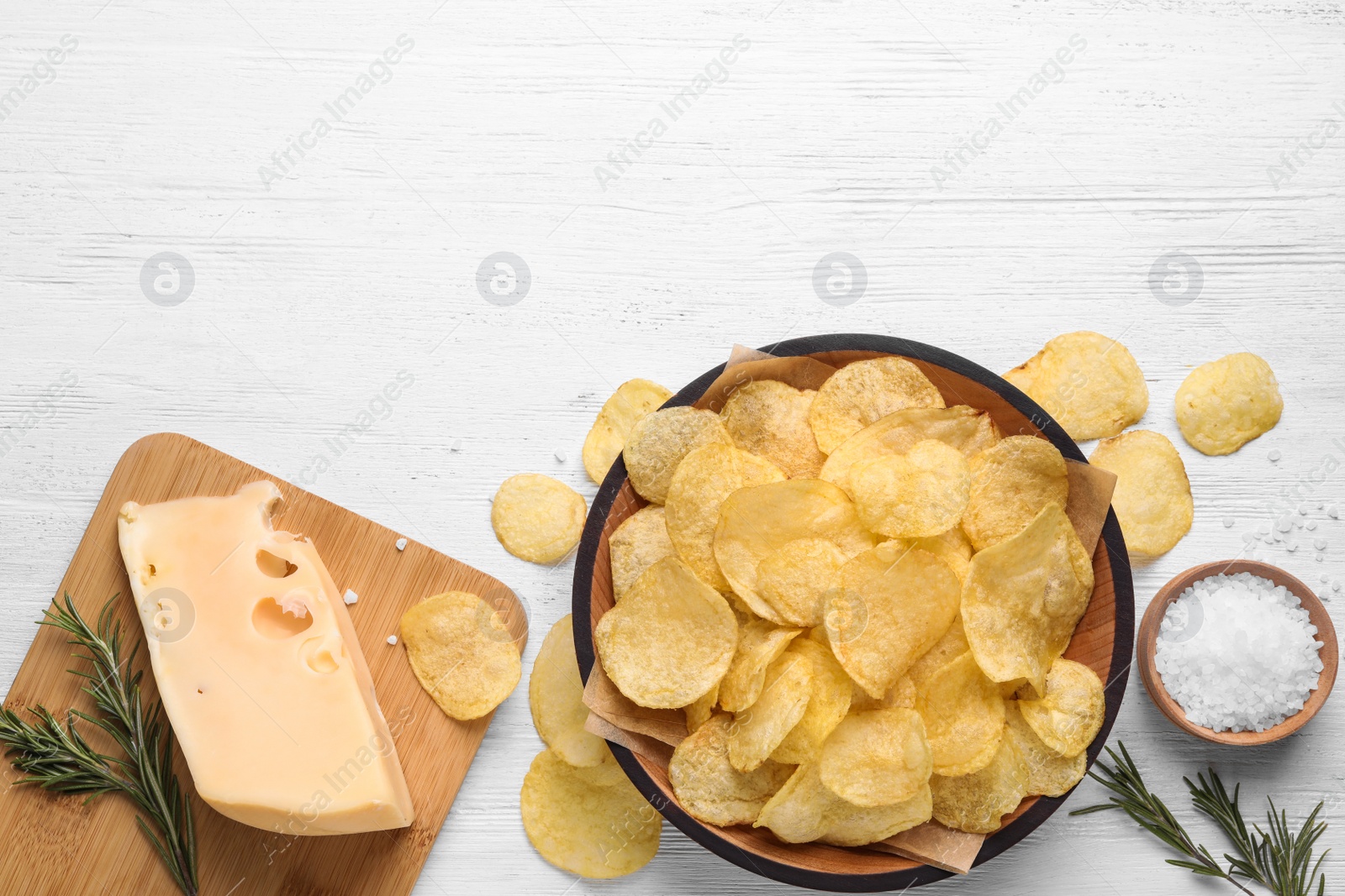 Photo of Flat lay composition with delicious crispy potato chips on table, space for text