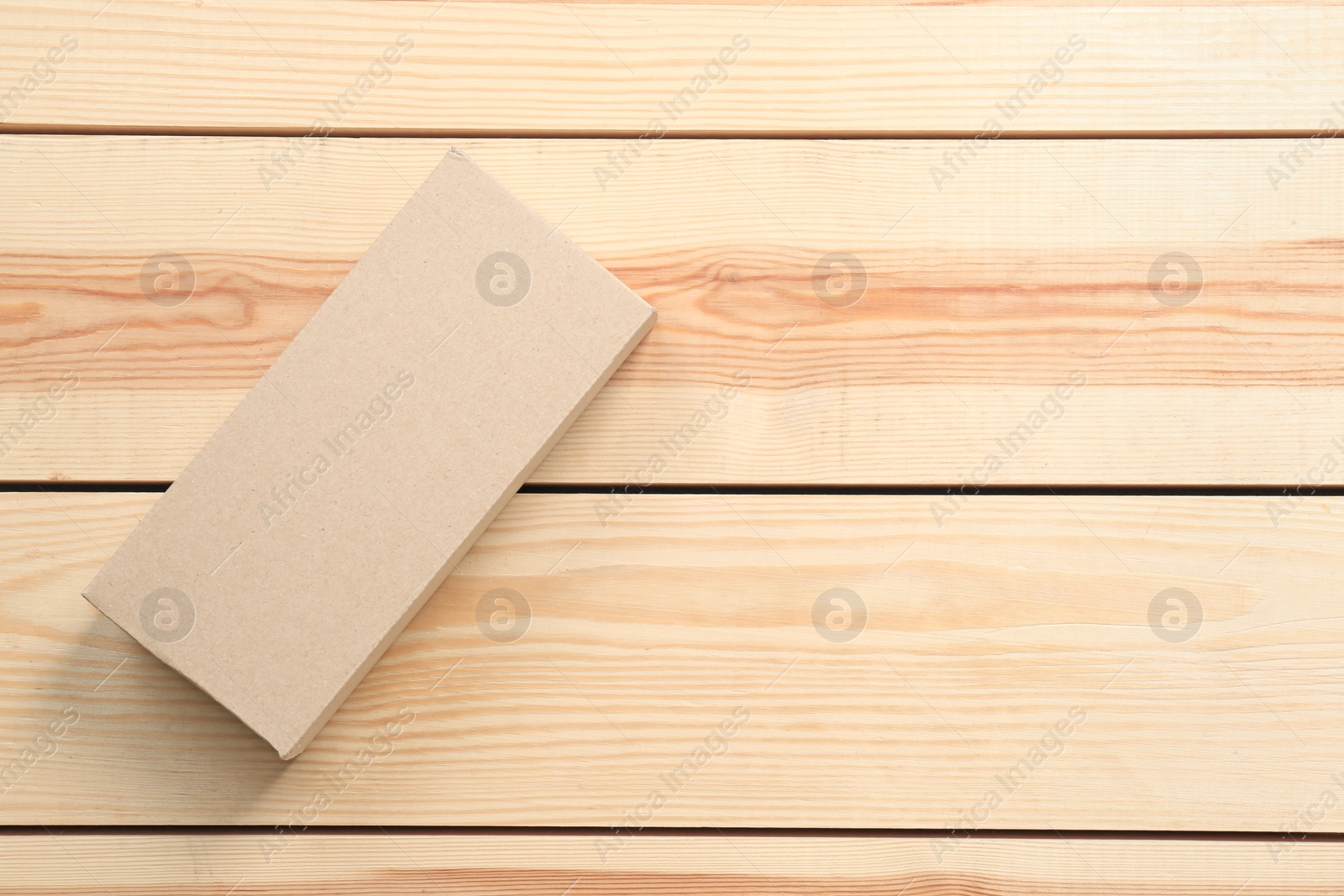 Photo of Cardboard box on wooden background