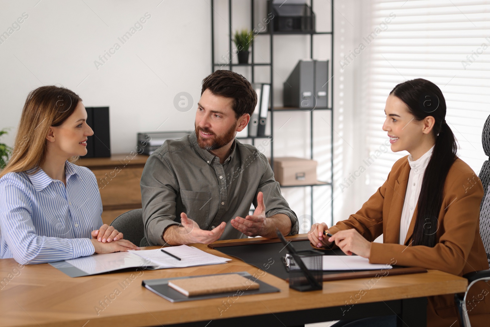 Photo of Couple having meeting with lawyer in office