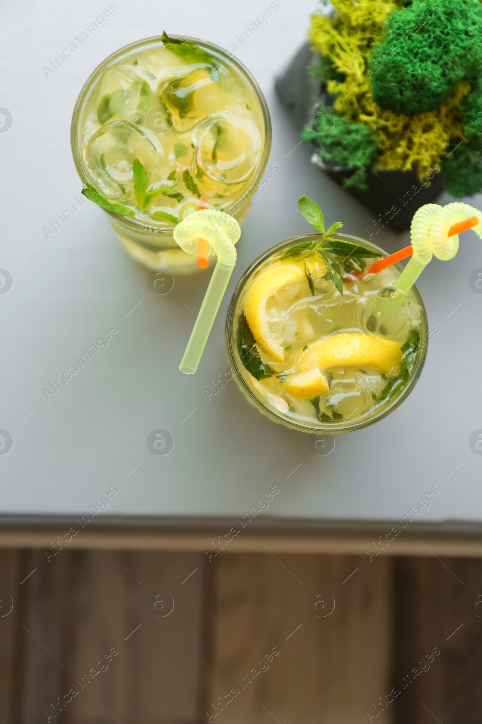Photo of Glasses of iced lemonade on table, top view
