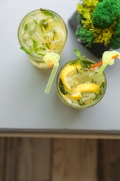 Glasses of iced lemonade on table, top view