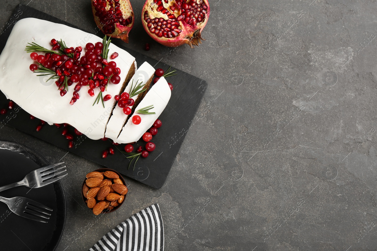 Photo of Flat lay composition with traditional classic Christmas cake on grey table. Space for text