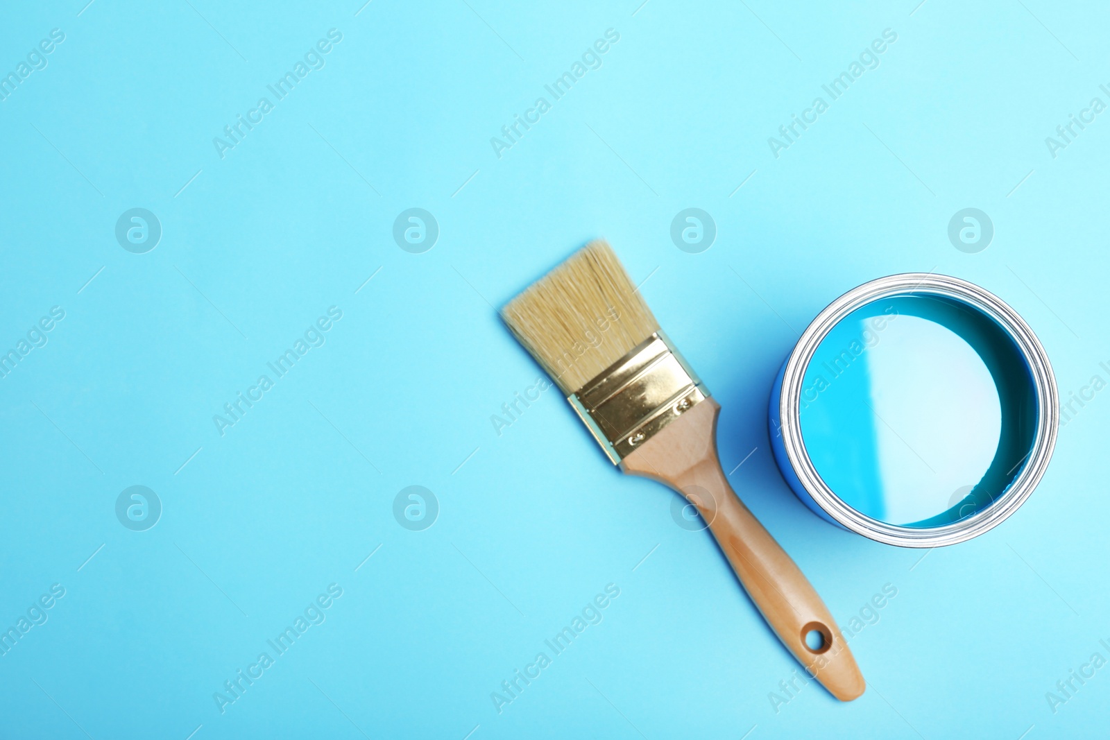 Photo of Flat lay composition with paint can and brush on color background. Space for text