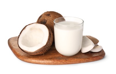 Glass of delicious vegan milk and coconuts on white background