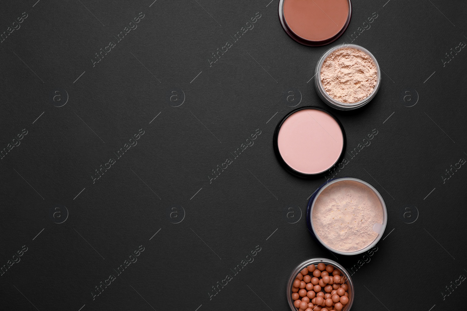 Photo of Different face powders on black background, flat lay. Space for text