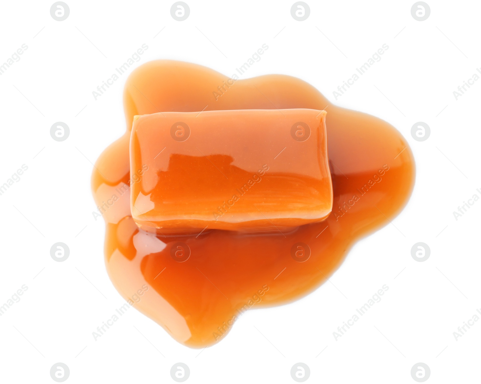 Photo of Delicious candy with caramel sauce on white background