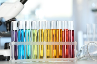 Test tubes with color liquids on table in laboratory