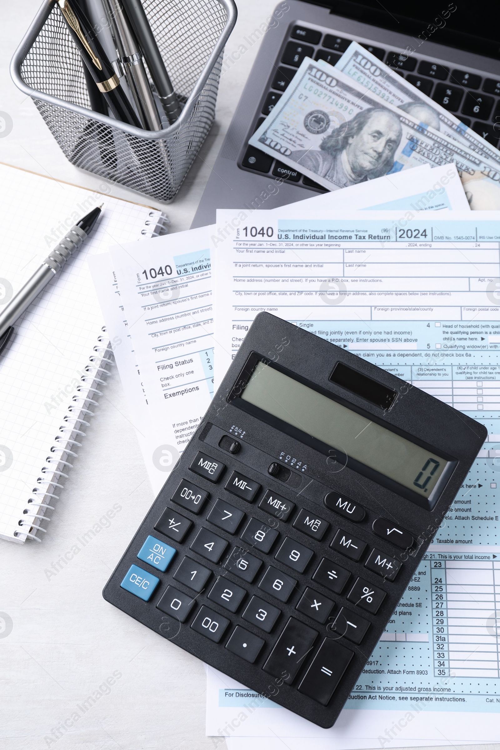 Photo of Tax accounting. Calculator, documents, money and stationery on light grey table, top view