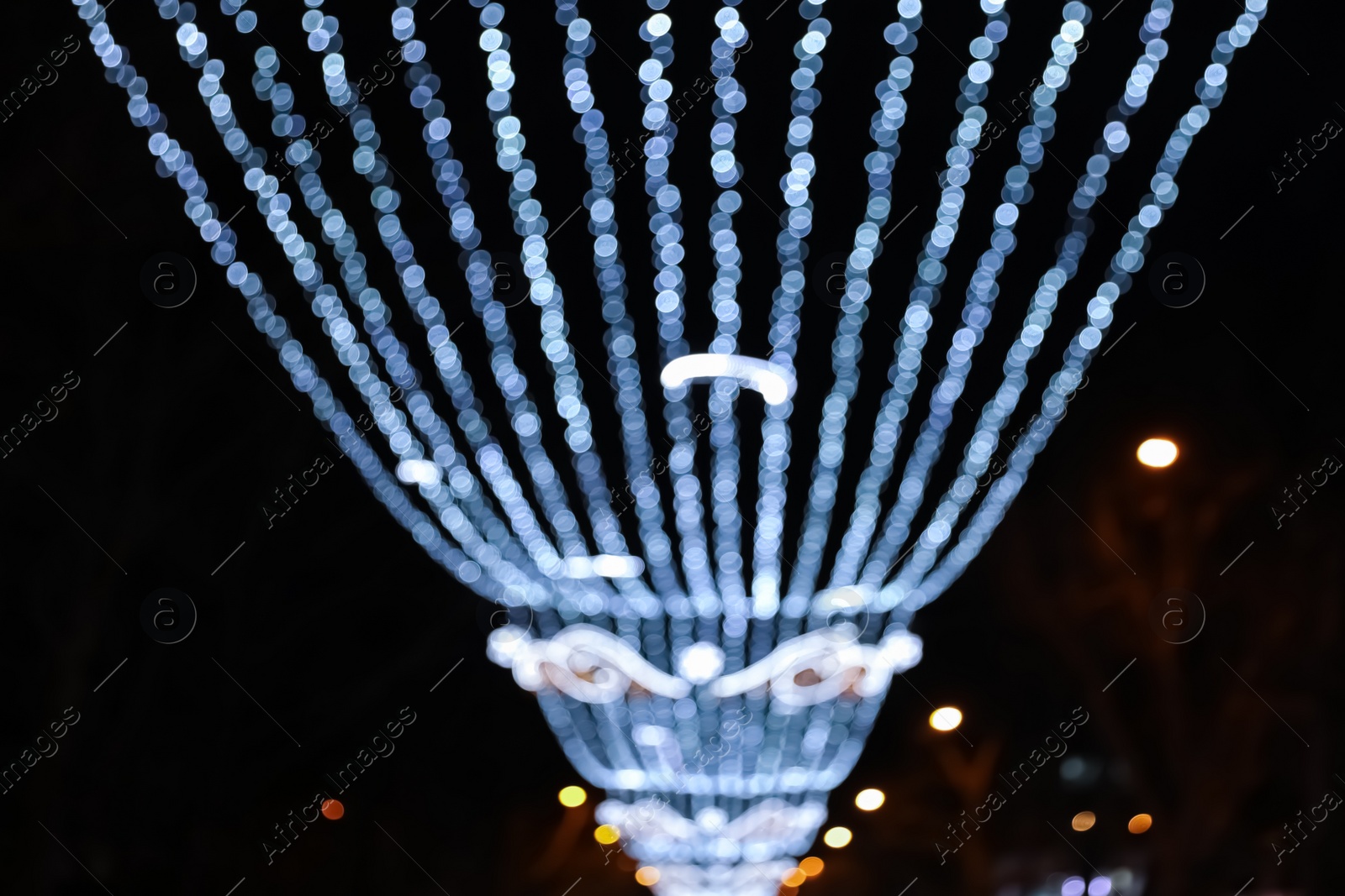 Photo of Beautiful bright Christmas decor outdoors, low angle view. Bokeh effect